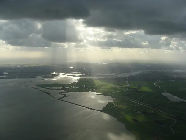Amsterdam behind the breaking sunlight.