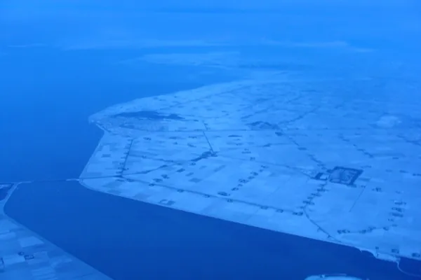 Rich in contrast: coming home from tropical Africa at dawn over a wintry Netherlands in mid-December. In the photo a frozen Noordoostpolder with the Ketelbrug on the left.